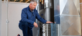 man checking furnace filter